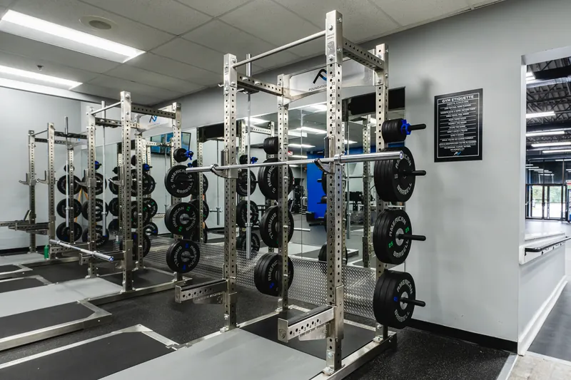 New squat racks with bumper plates on lifting platforms at Foundation Fitness Annapolis